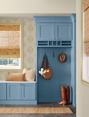 An entryway with built-in shelving, bench and coat hooks painted Smoky Azurite SW9148.