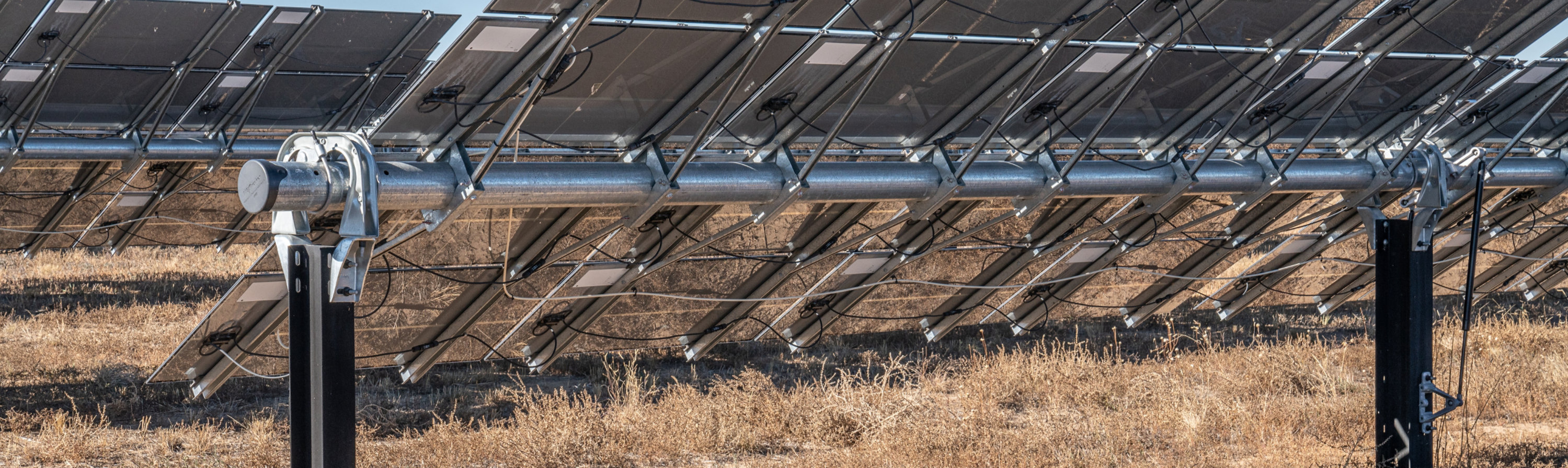 Rear view of solar panels supported by steel pile foundations at a utility-scale solar installation