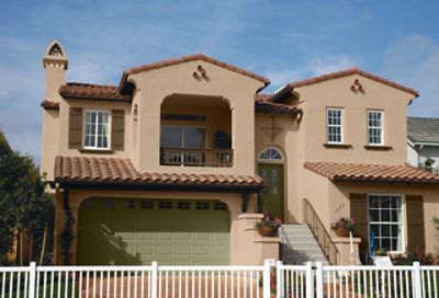 A beige painted spanish style home with dark green window trim.  S-W colors featured: SW 6108, SW 6153, SW 7729