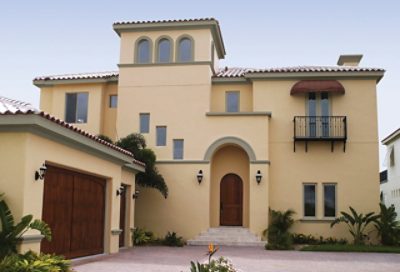 A yellow spanish style home with garage and front entry. S-W colors featured: SW 6134, SW 6165, SW 6055.
