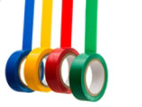 Four rolls of adhesive tape in blue, yellow, red, and green, hanging vertically with each tape partially unrolled