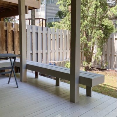 A stained wood deck with built-in benches by @designingthedillons.