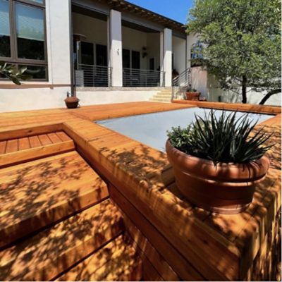 A stained wood deck surrounding a covered pool by @the.dexpert.