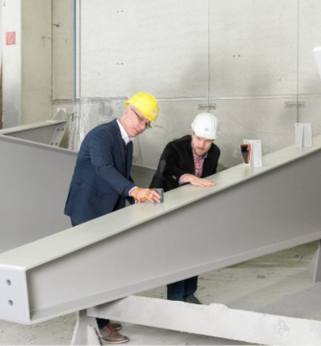 engineers inspect a steel beam