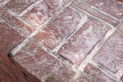Cleaning brick before applying paint.