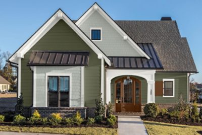 An exterior photo of a green newly painted vinyl siding house.