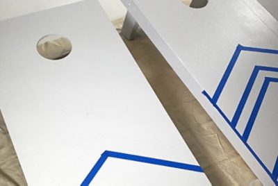 Drawing designs on two cornhole boards