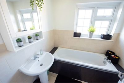 A bathroom with painted tile.