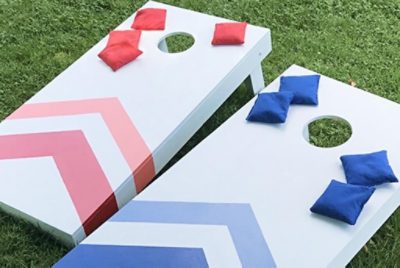 Two cornhole boards painted red and blue
