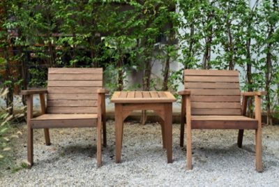 Two wooden patio chairs and a side table.