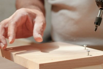 Two screws partially in a piece of wood.