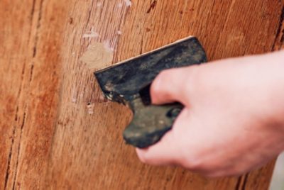 A person preppig wood paneling for paint.