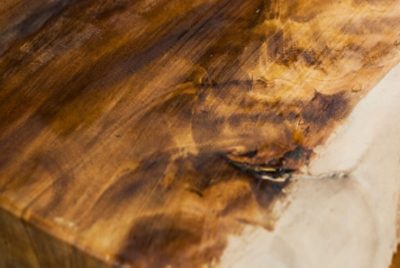 A partially stained piece of wood.