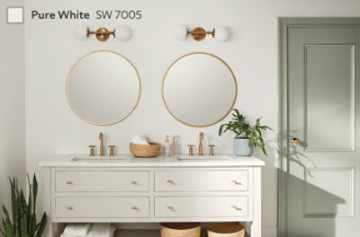 A bathroom with a double vanity and gold accents painted in Pure White SW 7005.