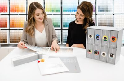 Two people looking at color swatches. 