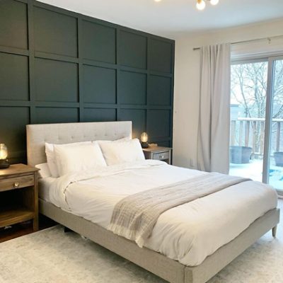 A bedroom with batten walls and dark green paint. SW color featured: SW 2809 Rookwood Shutter Green.