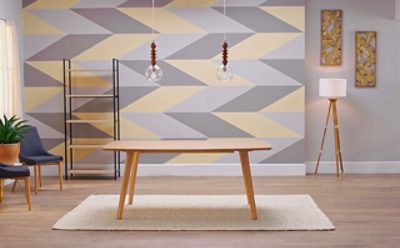A geometric accented wall with gray and yellow hues. SW color featured: SW 6001 Grayish.