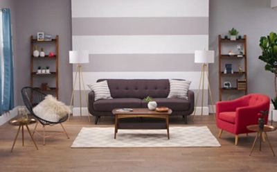 A living room with gray furniture and a gray striped wall.