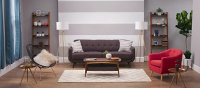 A living room with gray furniture and a gray striped wall.