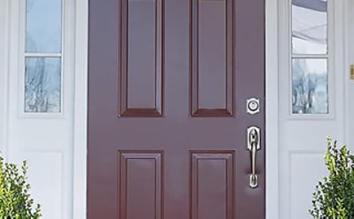 An exterior dark auburn painted front door. 