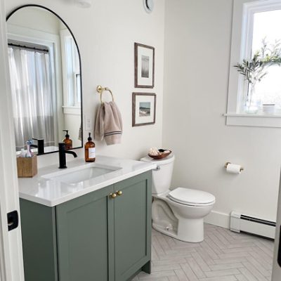 A dark green dresser with a white blanket draped over a drawer by @flawlessrooms. S-W colors featured: SW 6188 Shade Grown.