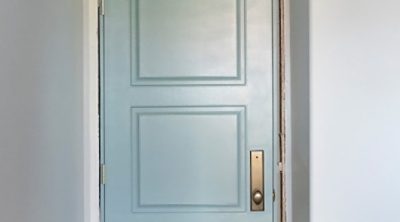 A green door with the first coat of paint. S-W color featured: SW  6213 Halycon Green.
