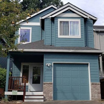 An exterior home with an attached garage door. S-W color featured: SW 6222.