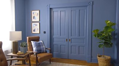 A living room with section doors drying with fresh paint. SW color featured: SW 6243 Distance.