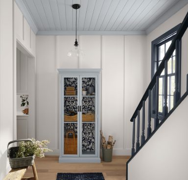 A neutral stairway with blue accent ceiling and trim