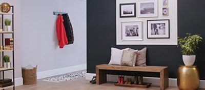 An entryway with a black accent wall and home decor.