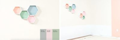 A white wall with hexagon shaped shelves and various paint swatch colors.