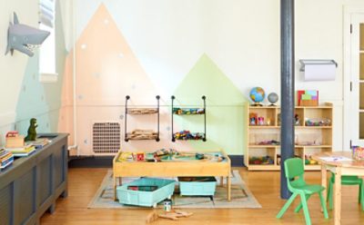 A playroom with a mountain mural. 
