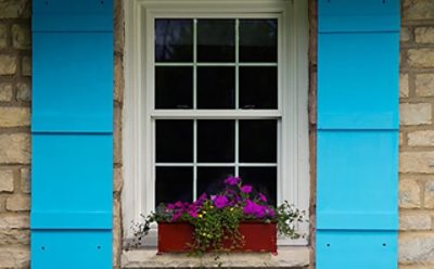 A set of bright blue painted window shutters. SW color featured: SW 6787 Fountain.