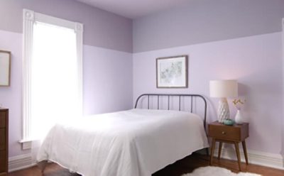 A bedroom wall with a dual-tone light purple bottom and dark purple top.