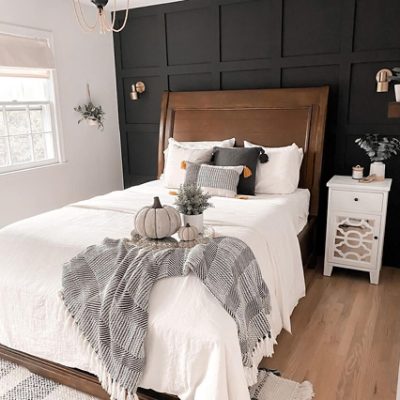A bedroom with a dark black batten wall. SW color featured: SW 6990 Caviar.