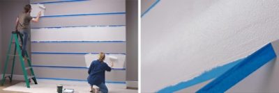 A couple is painting white horizontal stripes on a gray wall. S-W featured color: SW 7006 Extra White.