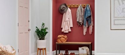 A red painted entryway closet with coat hooks. SW color featured: SW 7582.