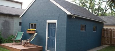 An outdoor brick painted garage. SW colors featured: SW 7620 Seaworthy.