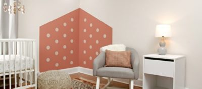 A white and dusty pink nursery with polka dot designs. SW colors featured: SW 9006 Rojo.