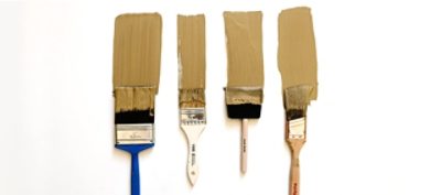 A set of four paint brushes with beige paint swatches.