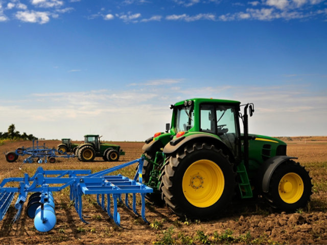 Green agricultural machines in field