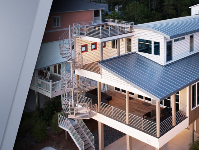 Photo of newly constructed residential home with grey curved metal roofs