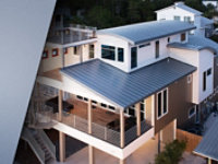  Photo of newly constructed residential home with grey curved metal roofs