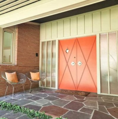 A retro style home with orange double front doors by @1957housedownsouth.