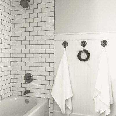 A bathroom with a tiled tub with walls painted in natural choice sw 7011 by @beautifulchaos_home.