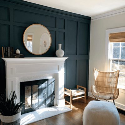 A living room with a white fireplace and wall behind it painted in mount etna sw 7625 by @noire_motif.