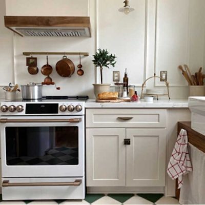 A neutral kitchen with light tan cabinets and copper accents by @ourgrowingstorey.