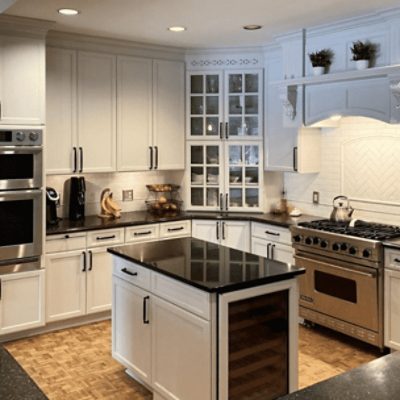 A large kitchen with an island painted in on the rocks sw 7671 by @roellpaintingcompany.