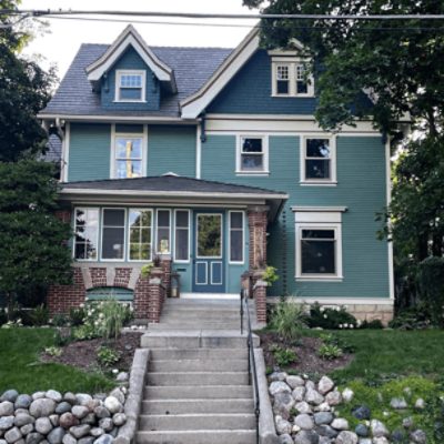 A house with long concrete front steps and exterior painted in SW 2811 rookwood blue green.