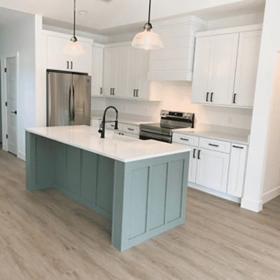 A kitchen island painted in studio blue green sw 0047 by @b_p_designco.